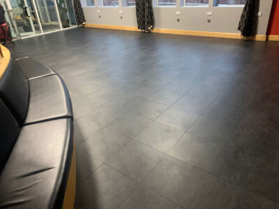 Black interlocking floor tiles used in an office reception